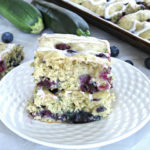 Easy dairy-free blueberry zucchini cake recipe with the lemon icing glaze. Bake it on the sheet pan to make cake bars. #dairyfree #sheetcake #zucchinicake #lemonicing for full recipe on craftyforhome.com