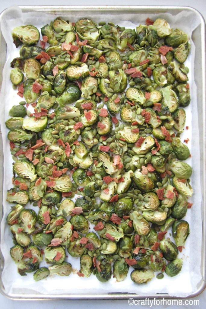 Oven Roasted Brussels Sprouts With Bacon | Easy oven roasted brussels sprouts recipe with maple glaze and topped it up with crispy bacon. A quick and simple meal for the family. Dairy-free, nut-free, gluten-free. #sheetpan #dairyfree #nutfree #roastedbrusselssprouts #crispybacon for full recipe on www.craftyforhome.com