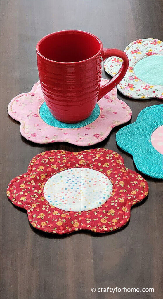 Red cup on top of pink flower coaster