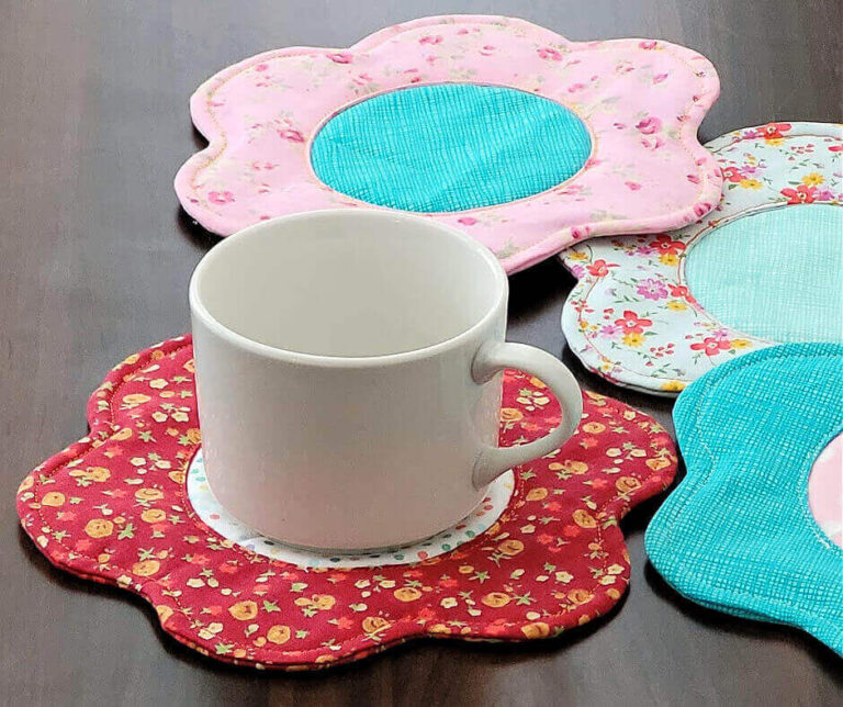 White cup with fabric flower shaped coaster