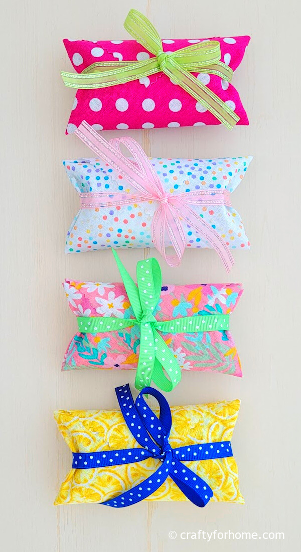 Pink, yellow fabric with blue, green, and pink ribbon.