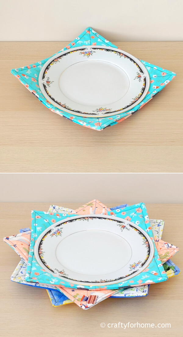 Two white dinner plate on fabric cozy.