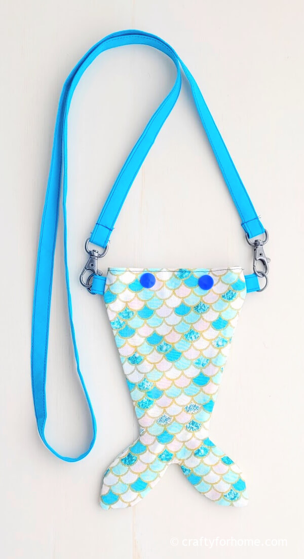 Mermaid coin bag with blue strap.