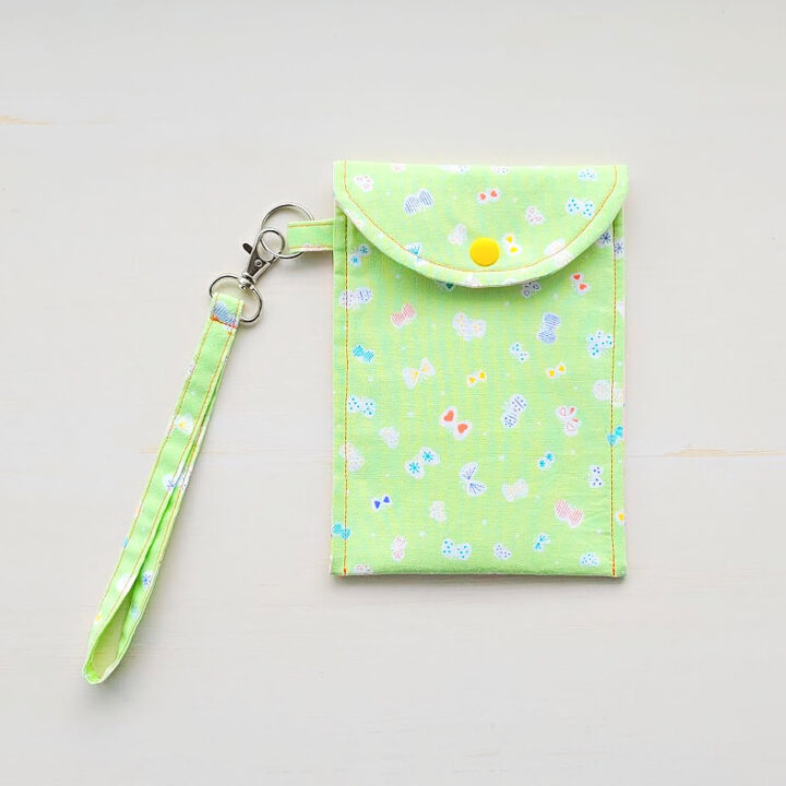 Green phone pouch with yellow button.