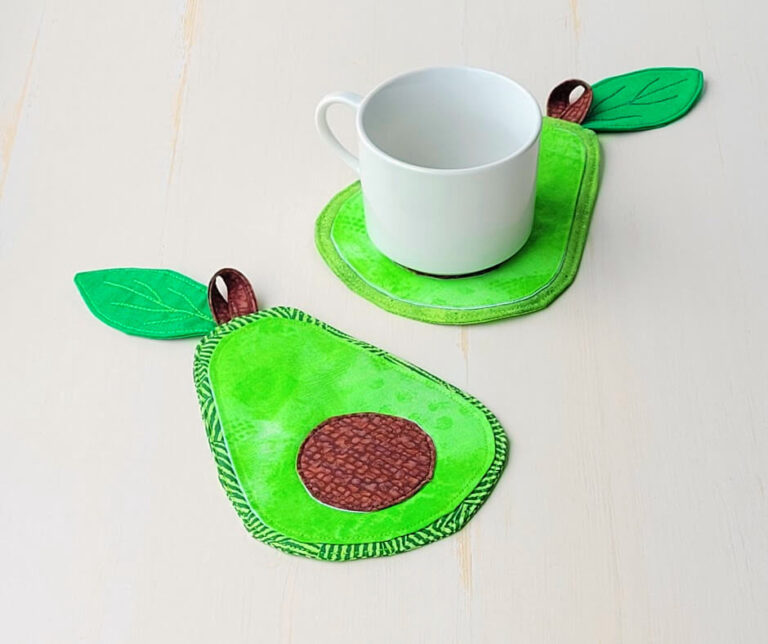 Avocado coaster from fabric with white mug.