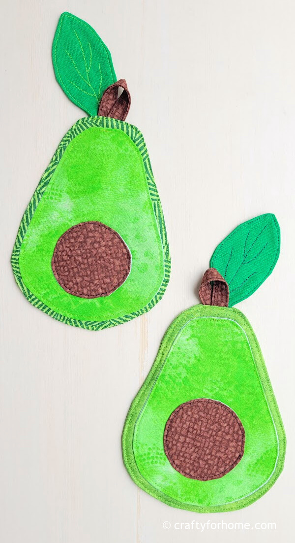 Two green fabric avocado shaped coaster.