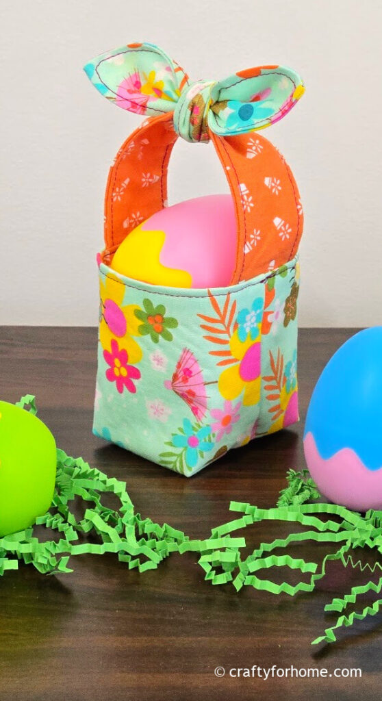 Plastic egg on the fabric basket.
