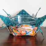 Convertible hot pad bowl cozy with string.