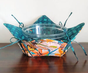 Convertible hot pad bowl cozy with string.