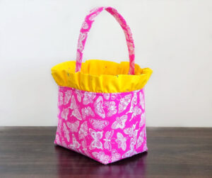 Fabric basket with ruffle top from pink fabric.